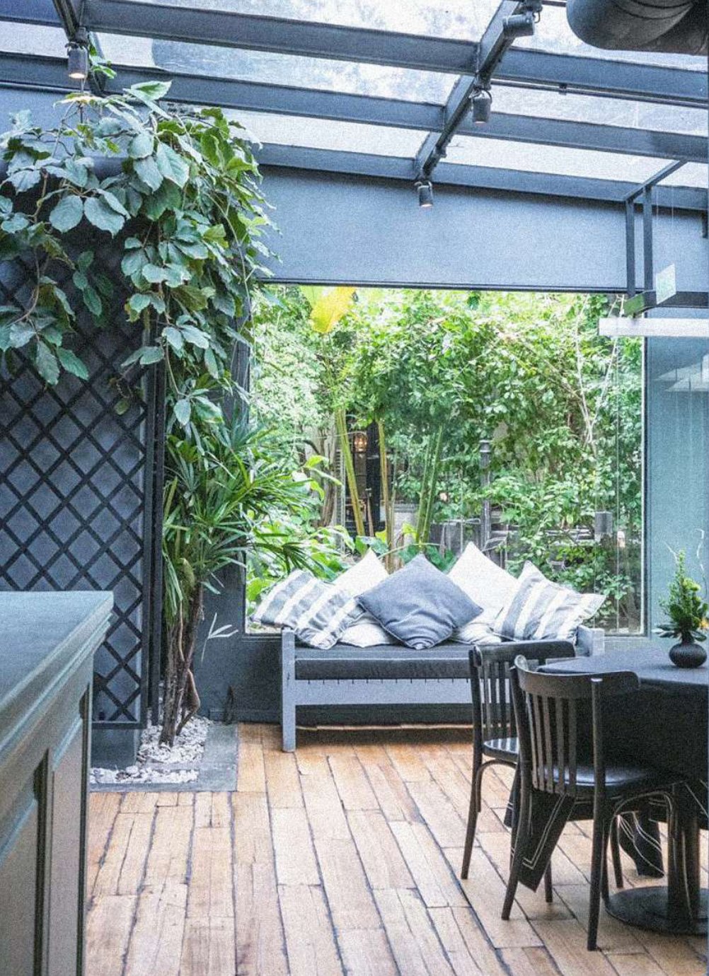 La Malbequería: a planted courtyard with timber deck and outdoor seating